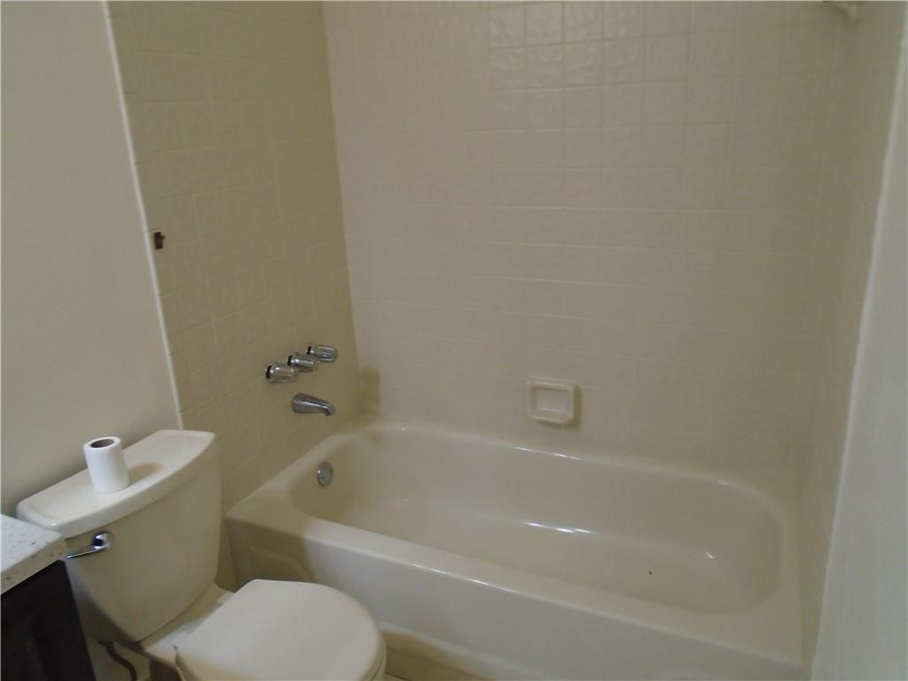 533 Banks Road Margate, FL 33063 - Photo 16 of 31 a white bath tub sitting next to a white toilet