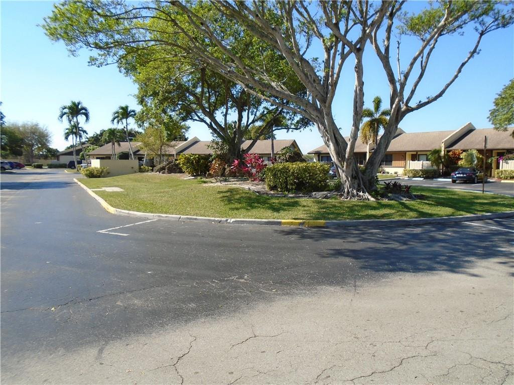 533 Banks Road Margate, FL 33063 - Photo 25 of 31 a front view of a house with a yard and trees