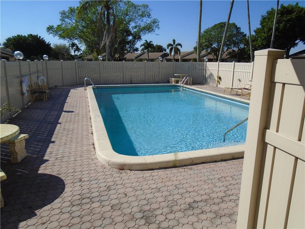 533 Banks Road Margate, FL 33063 - Photo 26 of 31 a view of a swimming pool with a chair