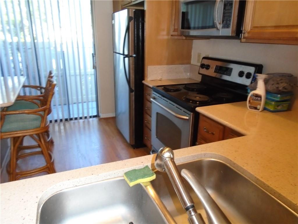 533 Banks Road Margate, FL 33063 - Photo 3 of 31 a kitchen with wooden floors and a sink