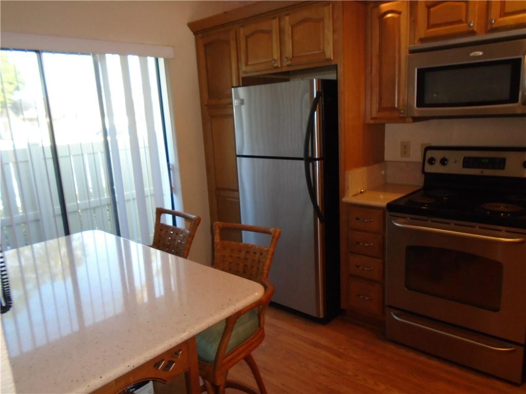 533 Banks Road Margate, FL 33063 - Photo 5 of 31 a kitchen with stainless steel appliances a dining table and a refrigerator