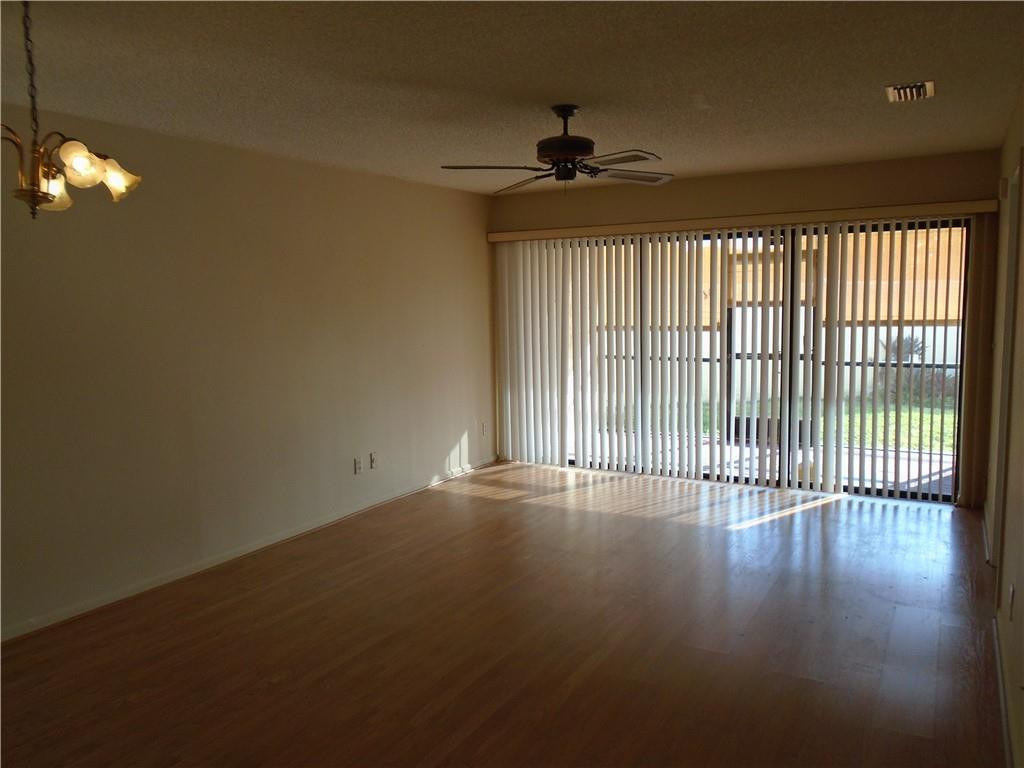 533 Banks Road Margate, FL 33063 - Photo 9 of 31 a view of an empty room with wooden floor and a window