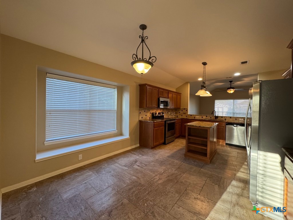 318 Silverado Trail Victoria, TX 77901 - Photo 4 of 14 a open kitchen with cabinets table and stainless steel appliances