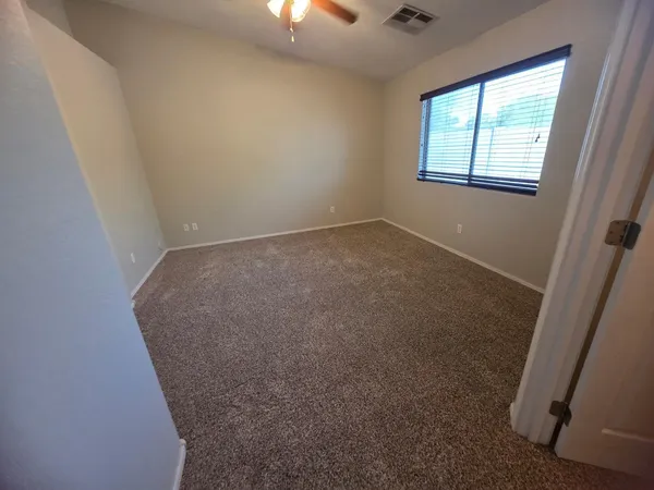 an empty room with a empty space and windows