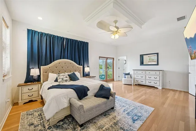 a bedroom with a bed and a chandelier