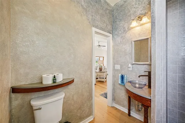 a front view of a building with street and trees