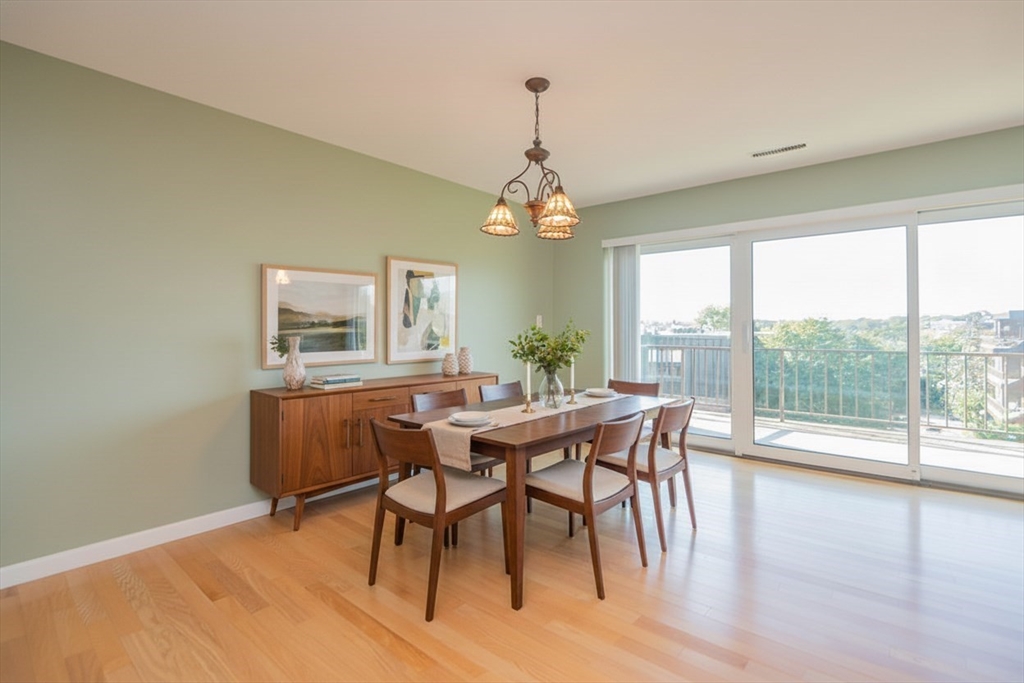 1006 Paradise Road, Unit PHO Swampscott, MA 01907 - Photo 2 of 27 a dining room with furniture window wooden floor