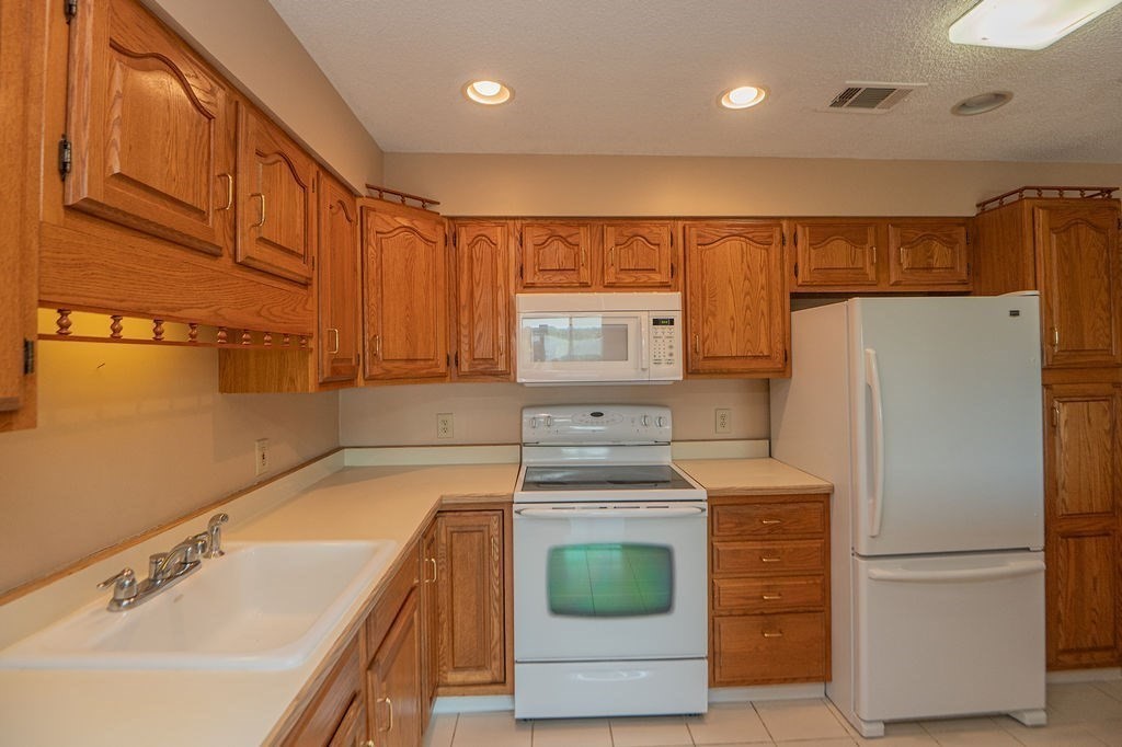 1006 Paradise Road, Unit PHO Swampscott, MA 01907 - Photo 4 of 27 a kitchen with a refrigerator sink and stove