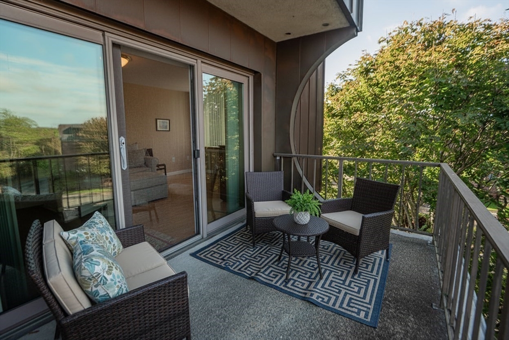 1006 Paradise Road, Unit PHO Swampscott, MA 01907 - Photo 9 of 27 a view of a porch with furniture and a yard