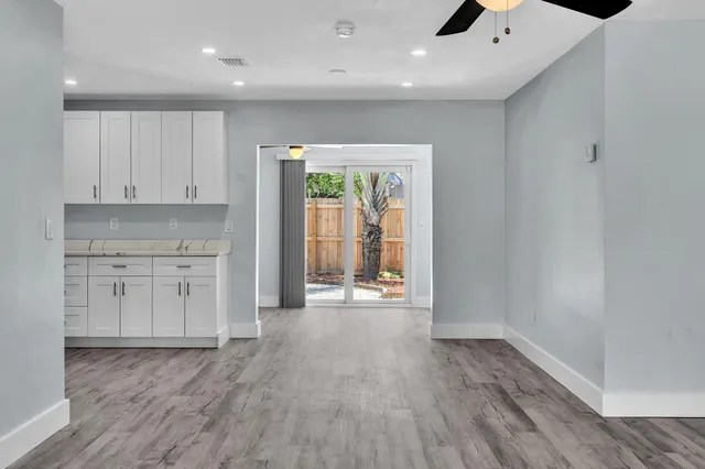 a large kitchen with stainless steel appliances granite countertop a large counter top and a stove top oven