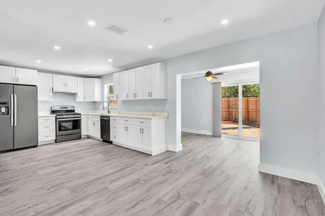 a kitchen with a refrigerator stove and a sink