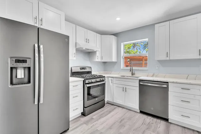 a kitchen that has a sink and a window in it
