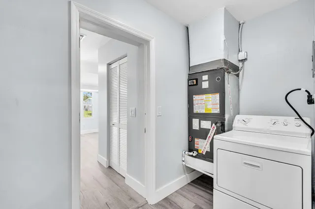 a view of a room with wooden floor and a window