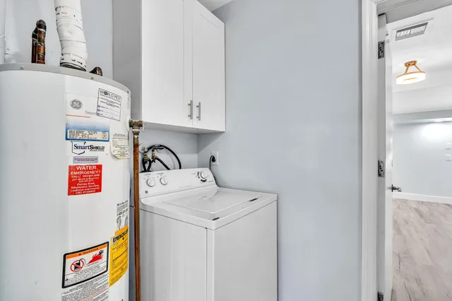 a bathroom with a toilet a sink a mirror and a window