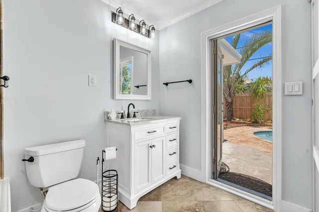a bathroom with a granite countertop toilet and a shower