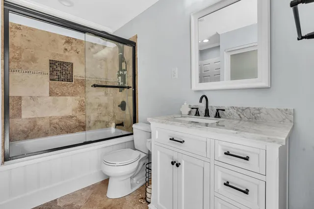 a view of a room with wooden floor and ceiling fan