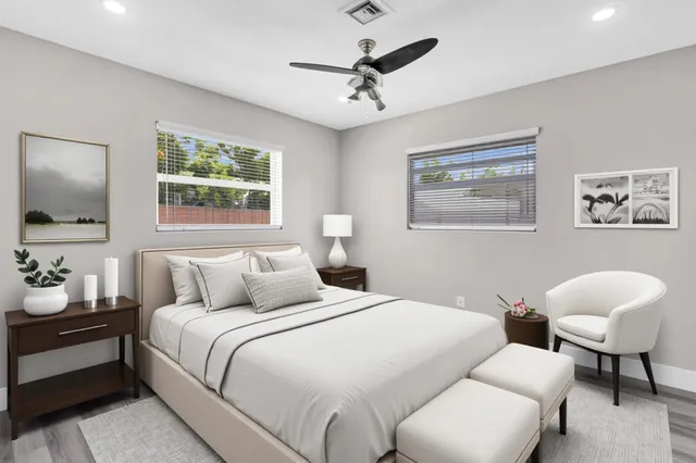 a view of wooden floor and a chandelier fan in a room