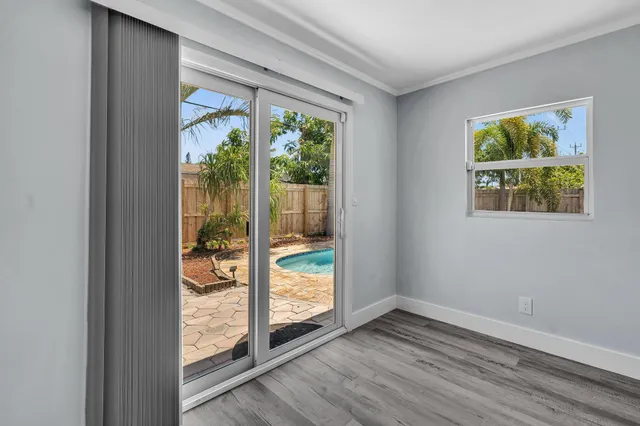 a backyard of a house with table and chairs