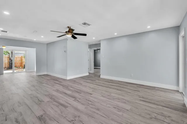 wooden floor in an empty room with a window