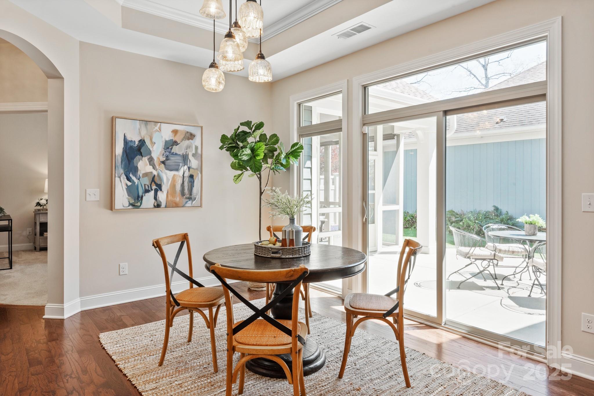 1128 Avalon Place Matthews, NC 28104 - Photo 13 of 39 a dining room with furniture a chandelier and wooden floor