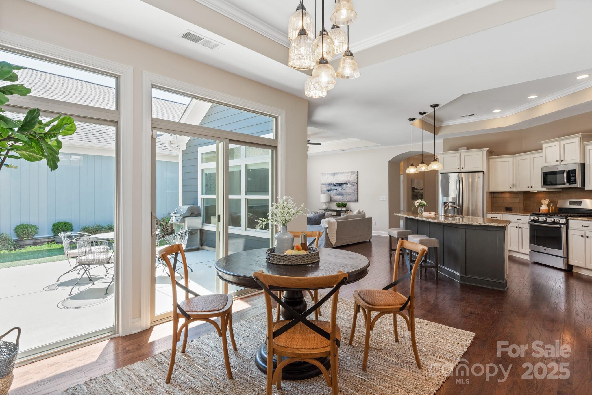 1128 Avalon Place Matthews, NC 28104 - Photo 15 of 39 a view of a dining room with furniture window and wooden floor