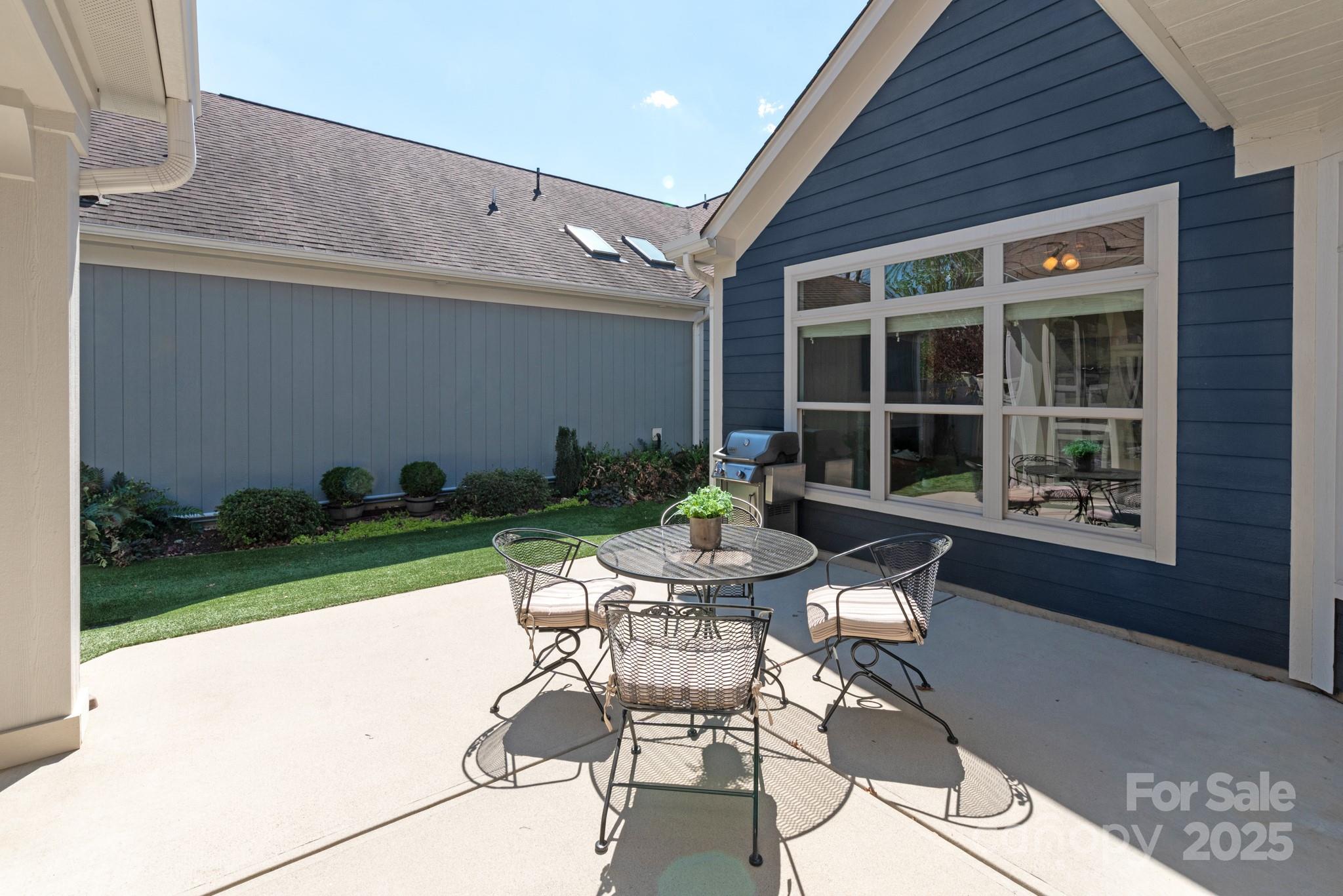 1128 Avalon Place Matthews, NC 28104 - Photo 17 of 39 a table and chairs in front of a house