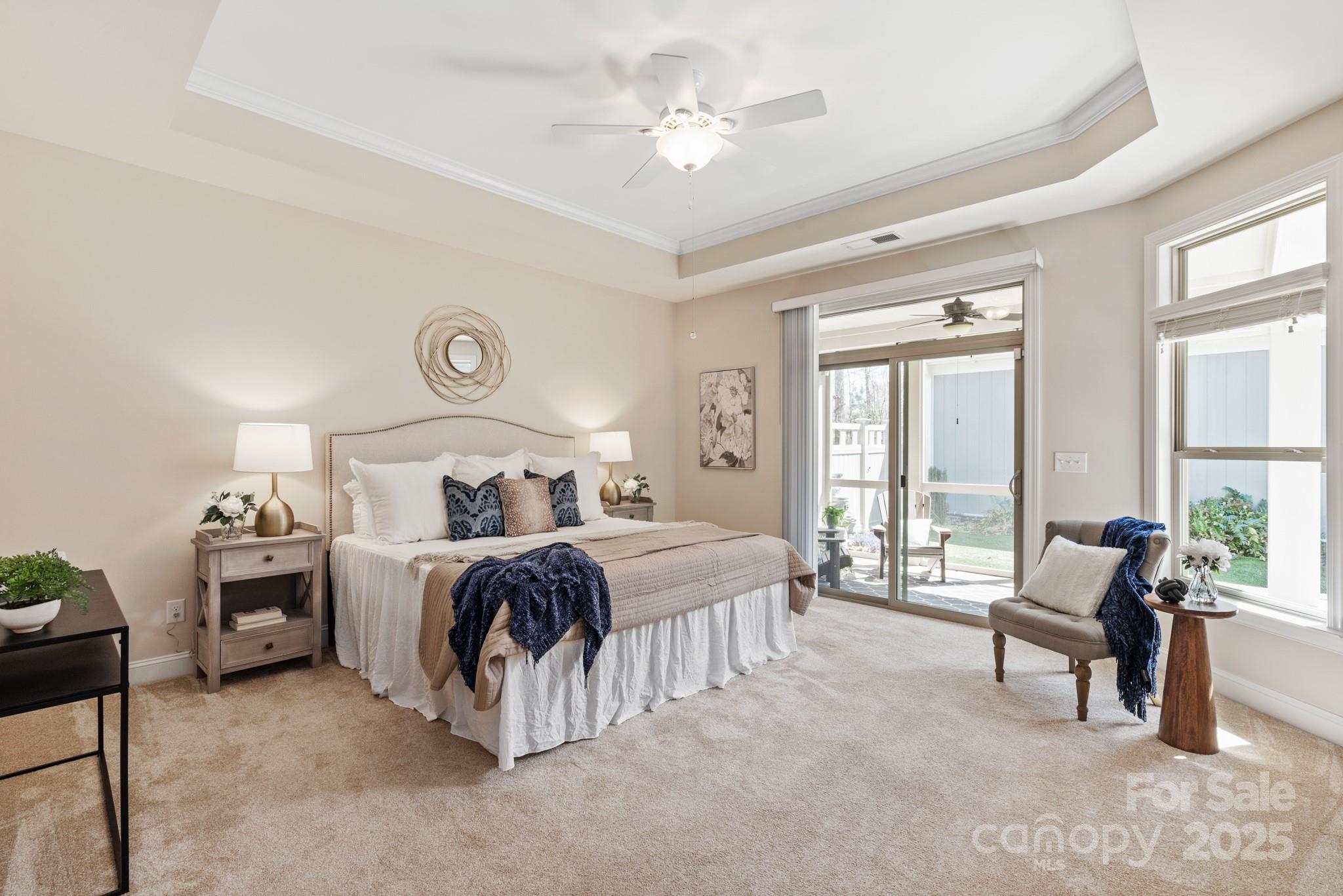 1128 Avalon Place Matthews, NC 28104 - Photo 20 of 39 a spacious bedroom with a bed and a chandelier