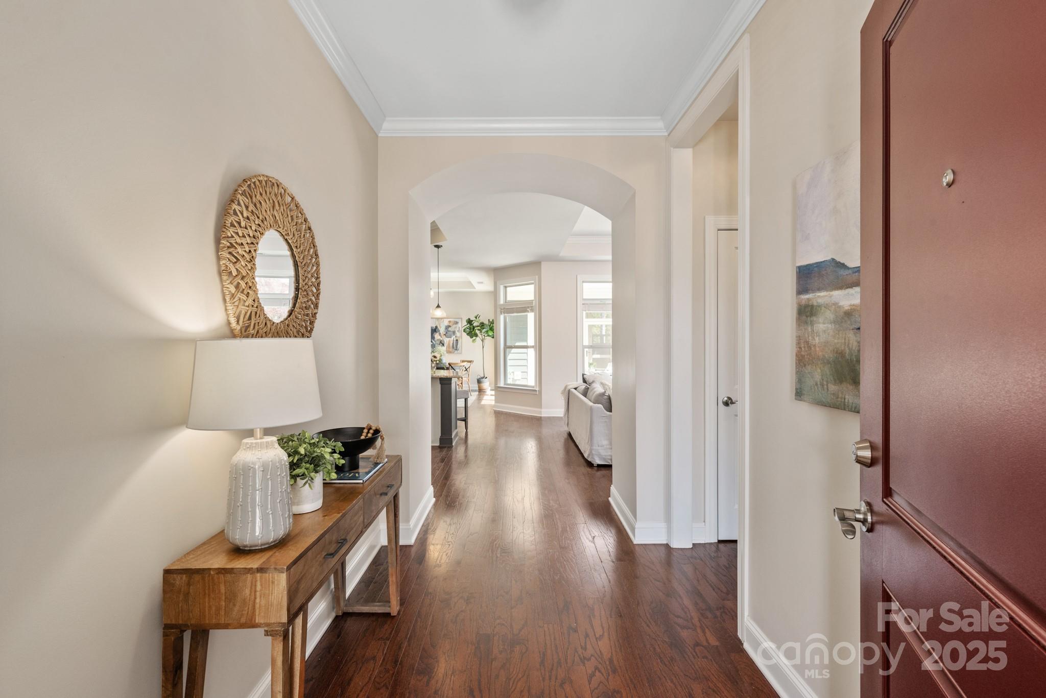 1128 Avalon Place Matthews, NC 28104 - Photo 3 of 39 a view of a hallway with wooden floor table and chairs
