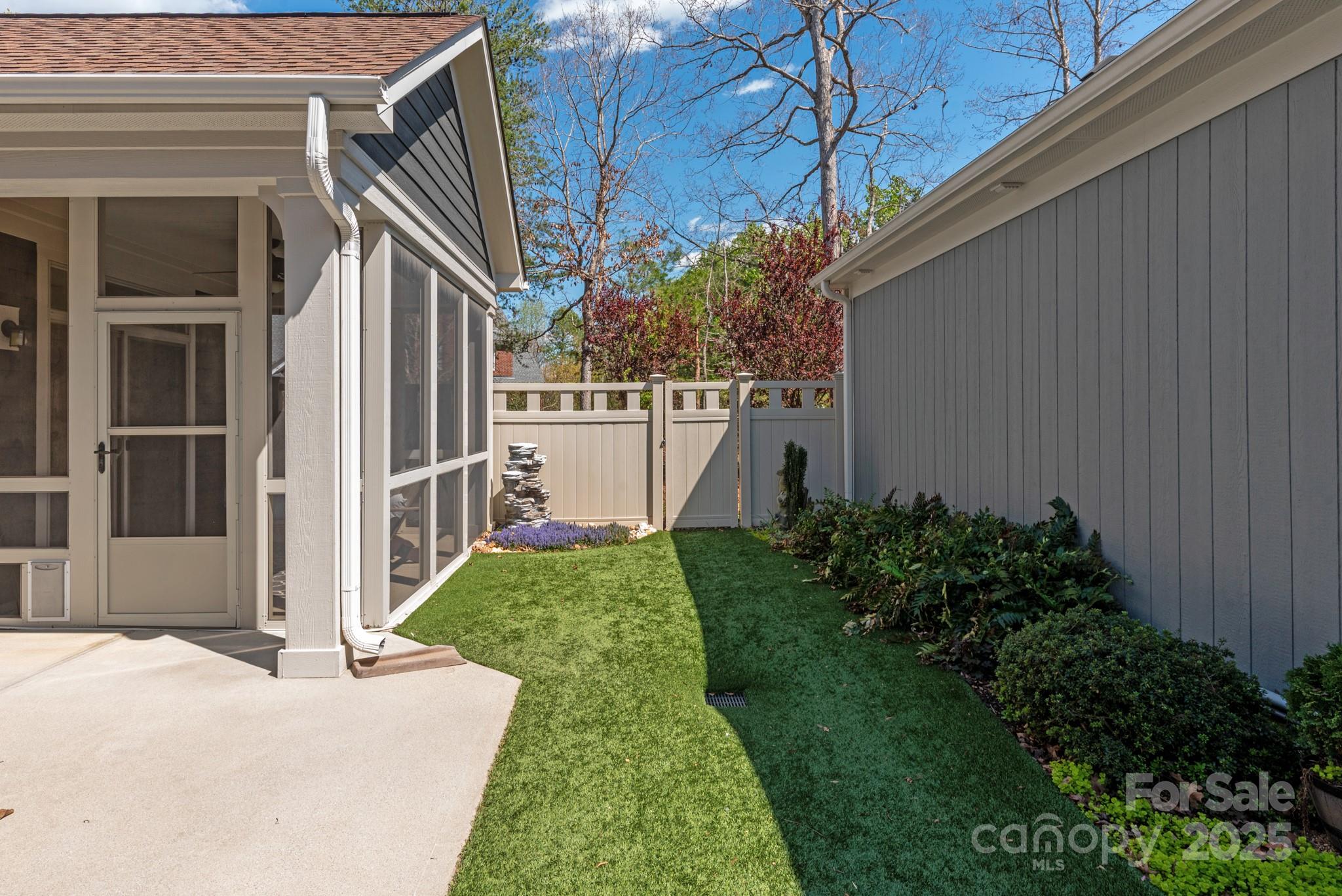 1128 Avalon Place Matthews, NC 28104 - Photo 33 of 39 a view of a house with a yard and flower plants