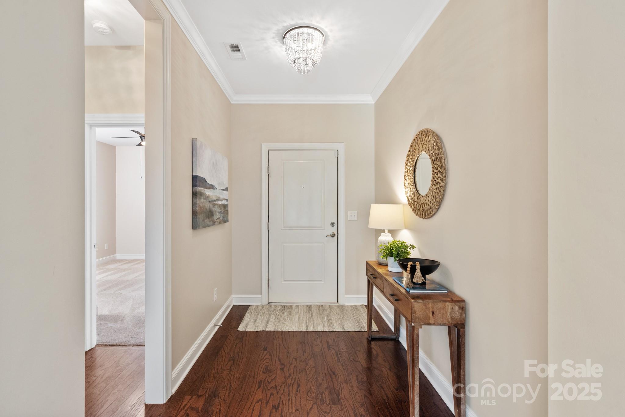 1128 Avalon Place Matthews, NC 28104 - Photo 4 of 39 a view of a hallway with wooden floor and entryway