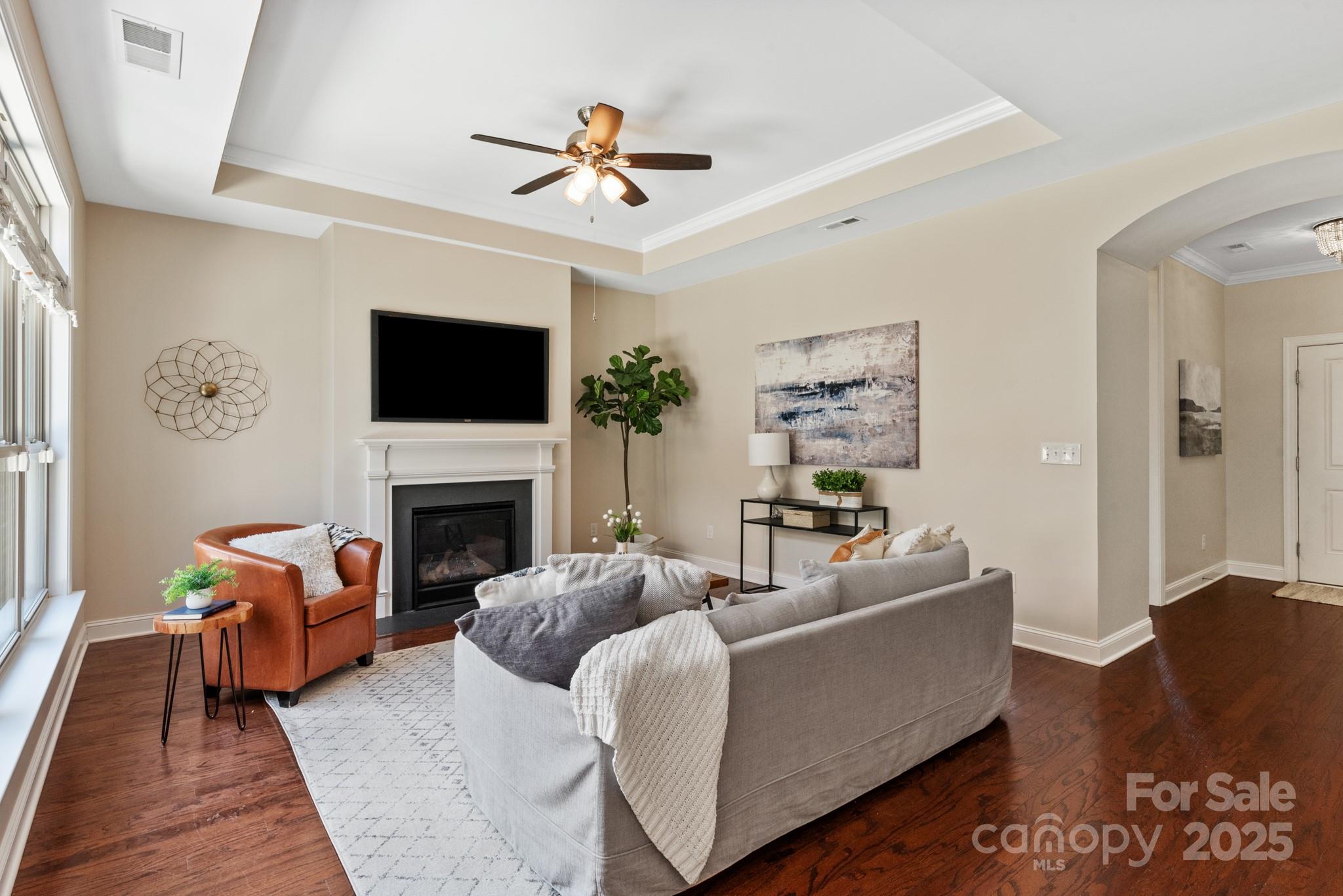 1128 Avalon Place Matthews, NC 28104 - Photo 5 of 39 a living room with furniture a fireplace and a flat screen tv
