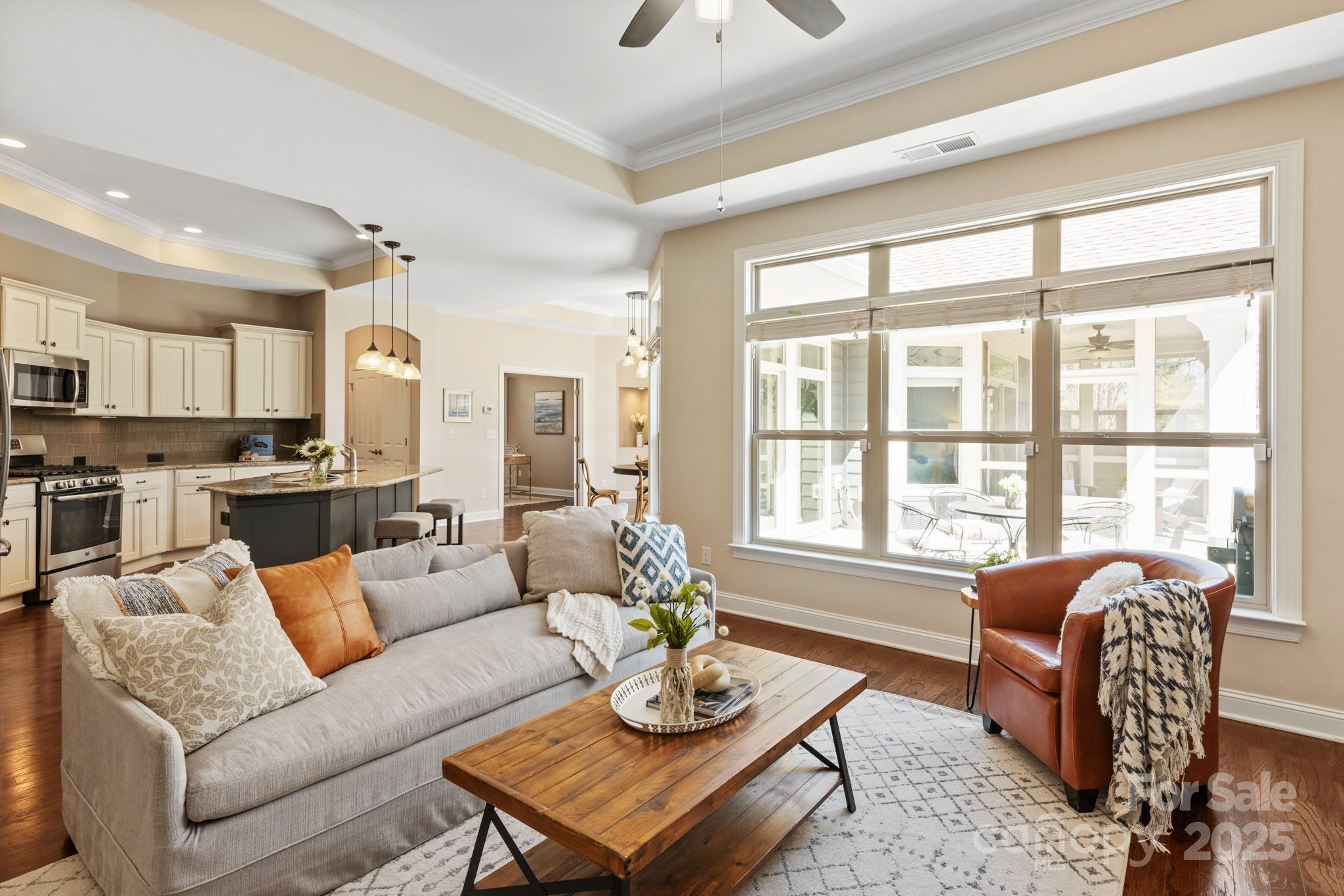 1128 Avalon Place Matthews, NC 28104 - Photo 8 of 39 a living room with furniture and floor to ceiling windows