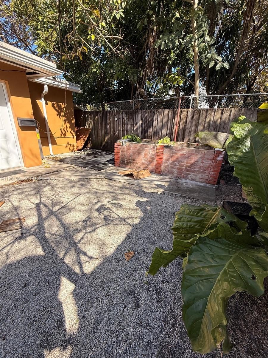 1037 Southwest 20th Avenue, Unit 2 Miami, FL 33135 - Photo 11 of 12 a view of backyard with a table and chair