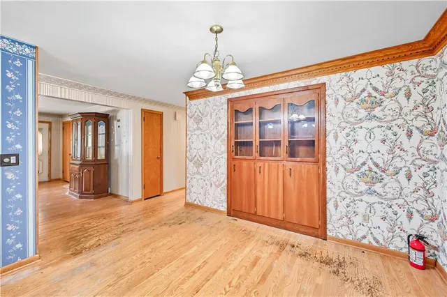 a open kitchen with stainless steel appliances granite countertop a refrigerator oven a sink dishwasher and a refrigerator with wooden floor