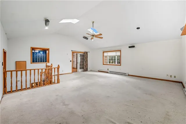 a view of a livingroom with furniture and a ceiling fan