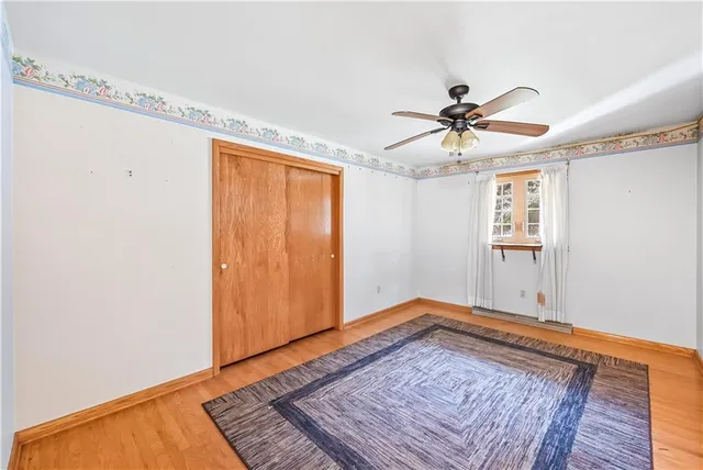 a view of a livingroom with a ceiling fan and window