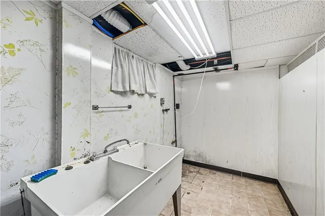 a kitchen with stainless steel appliances granite countertop a sink a stove and a refrigerator