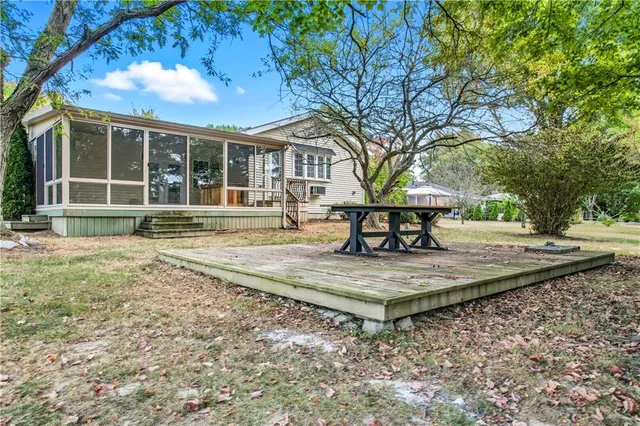a view of a house with backyard and a tree