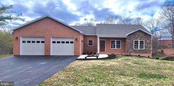 a view of a house with a yard and sitting area