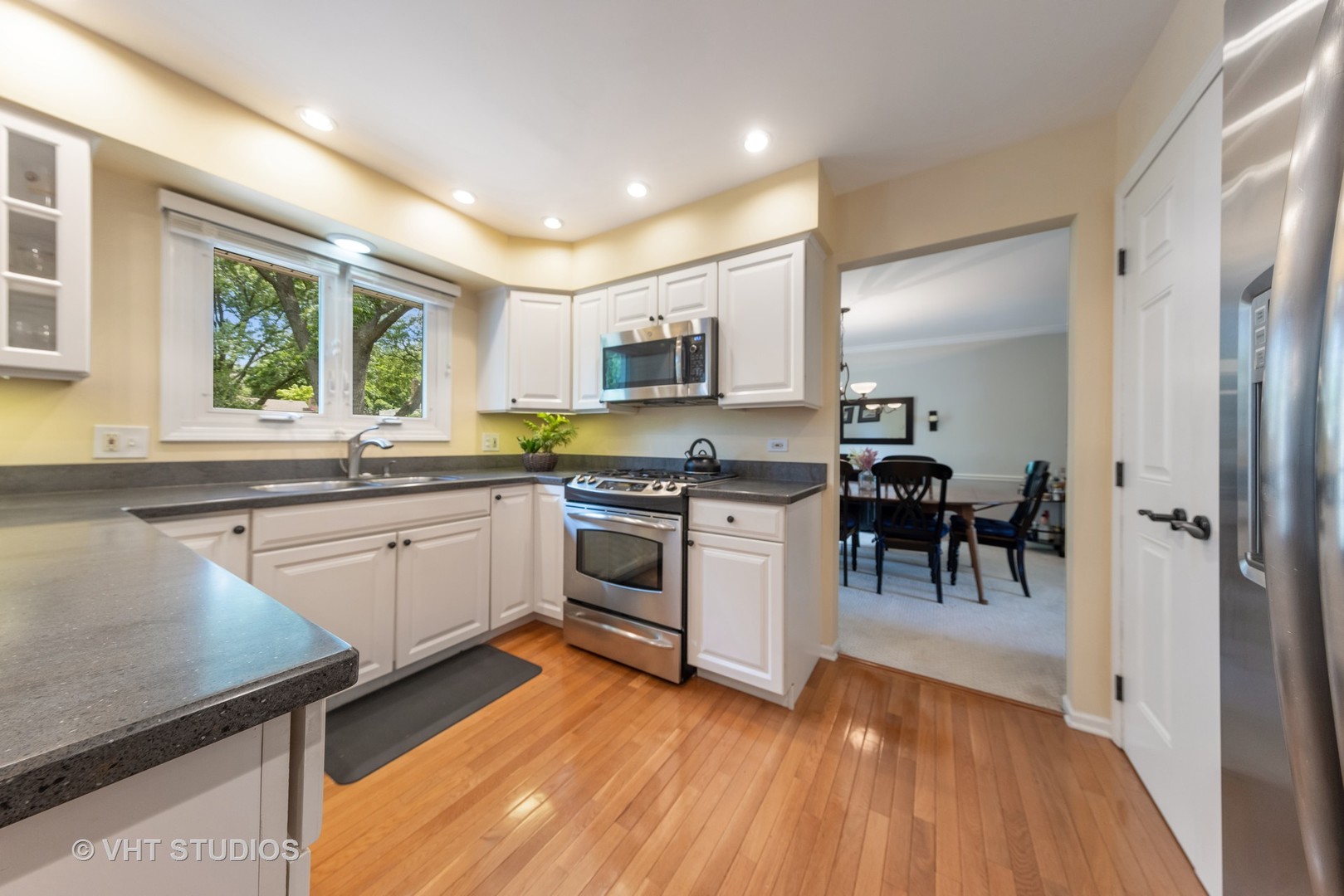1589 Orth Drive Wheaton, IL 60189 - Photo 11 of 23 a kitchen with sink cabinets and wooden floor