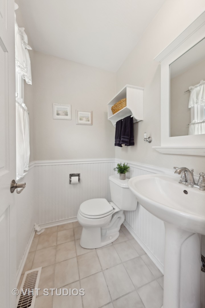 1589 Orth Drive Wheaton, IL 60189 - Photo 15 of 23 a bathroom with a sink toilet and mirror