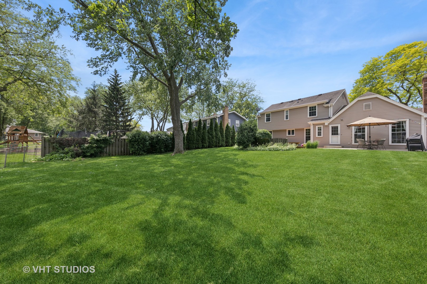 1589 Orth Drive Wheaton, IL 60189 - Photo 18 of 23 a front view of a house with a yard and trees