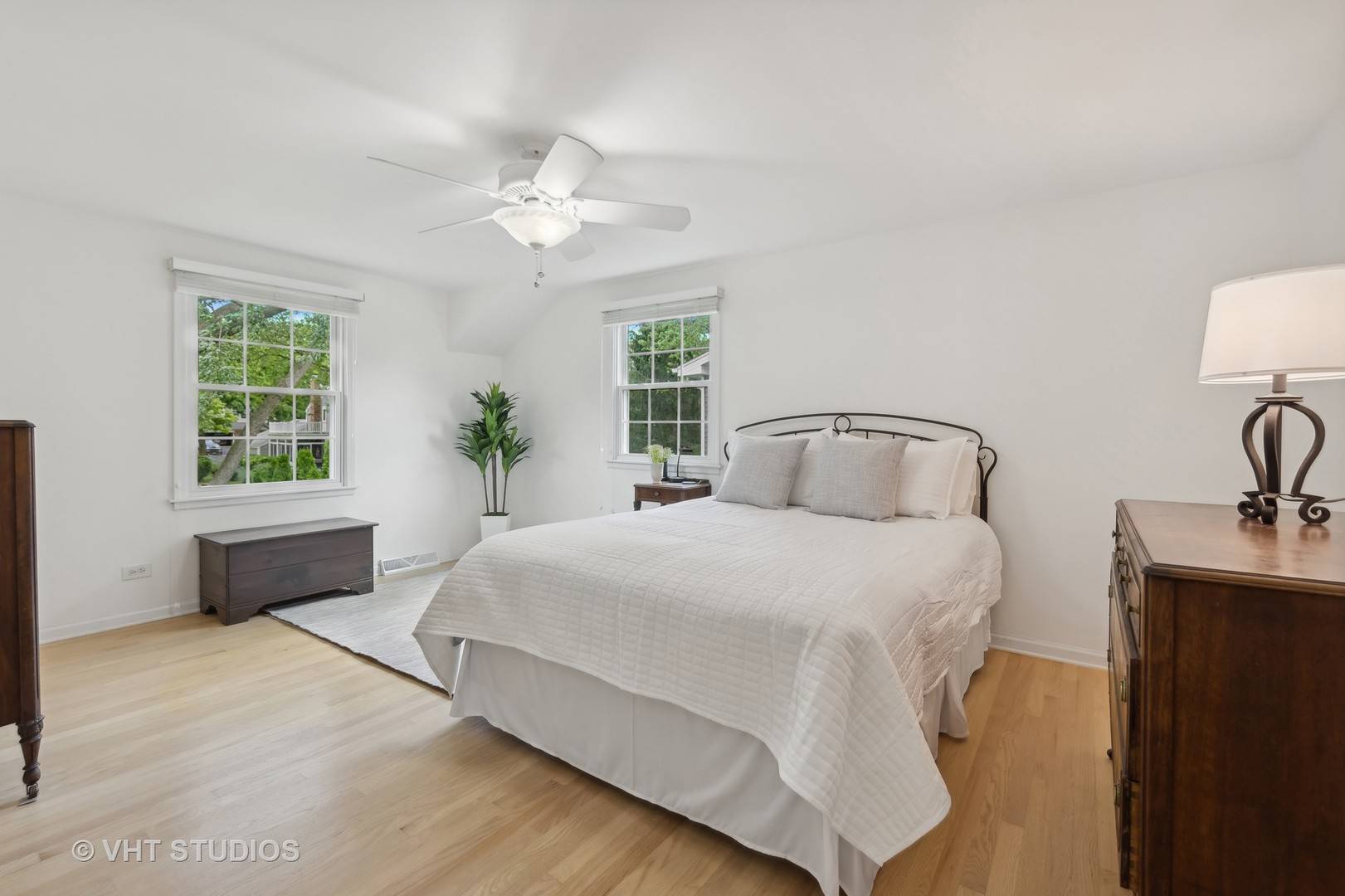 1589 Orth Drive Wheaton, IL 60189 - Photo 7 of 23 a bedroom with a large bed and a chandelier