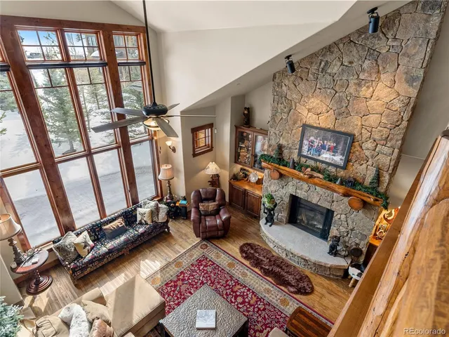 a living room with furniture a rug and a floor to ceiling window