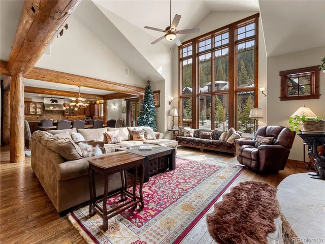 a living room with fireplace furniture and a large window