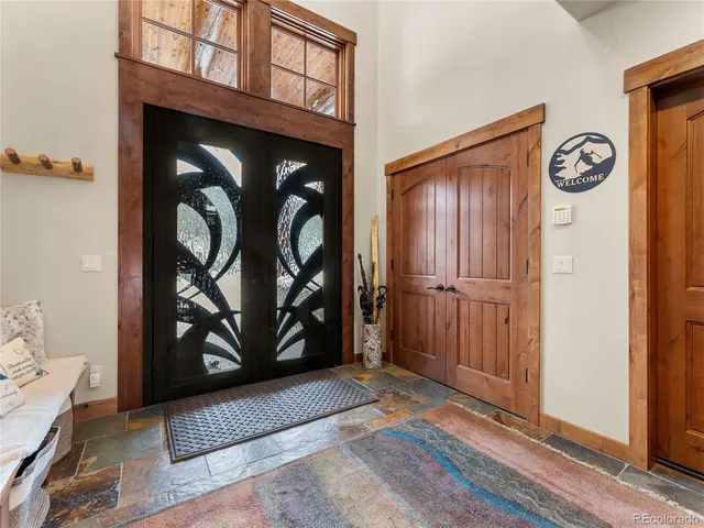 a view of a hallway with wooden floor and closet