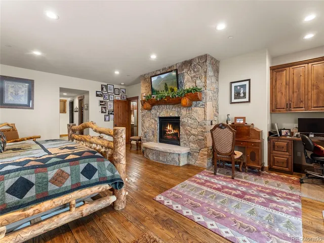 a bedroom with furniture and a fireplace