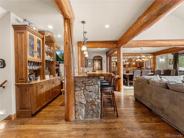 a living room with fireplace furniture and a wooden floor