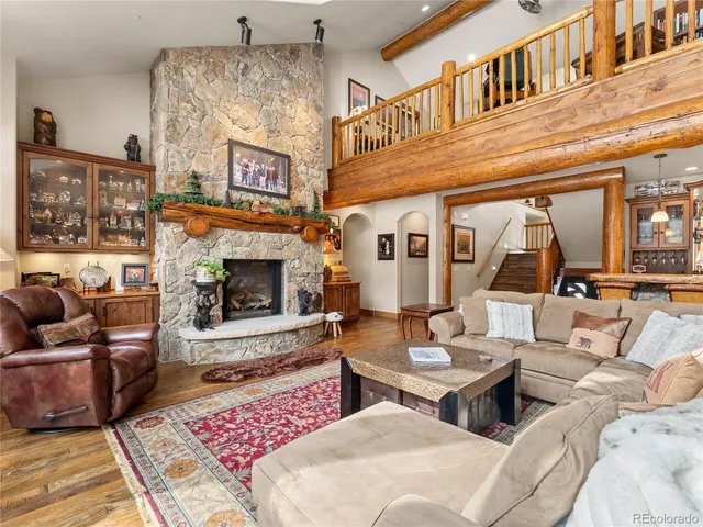 a living room with furniture fireplace and rug