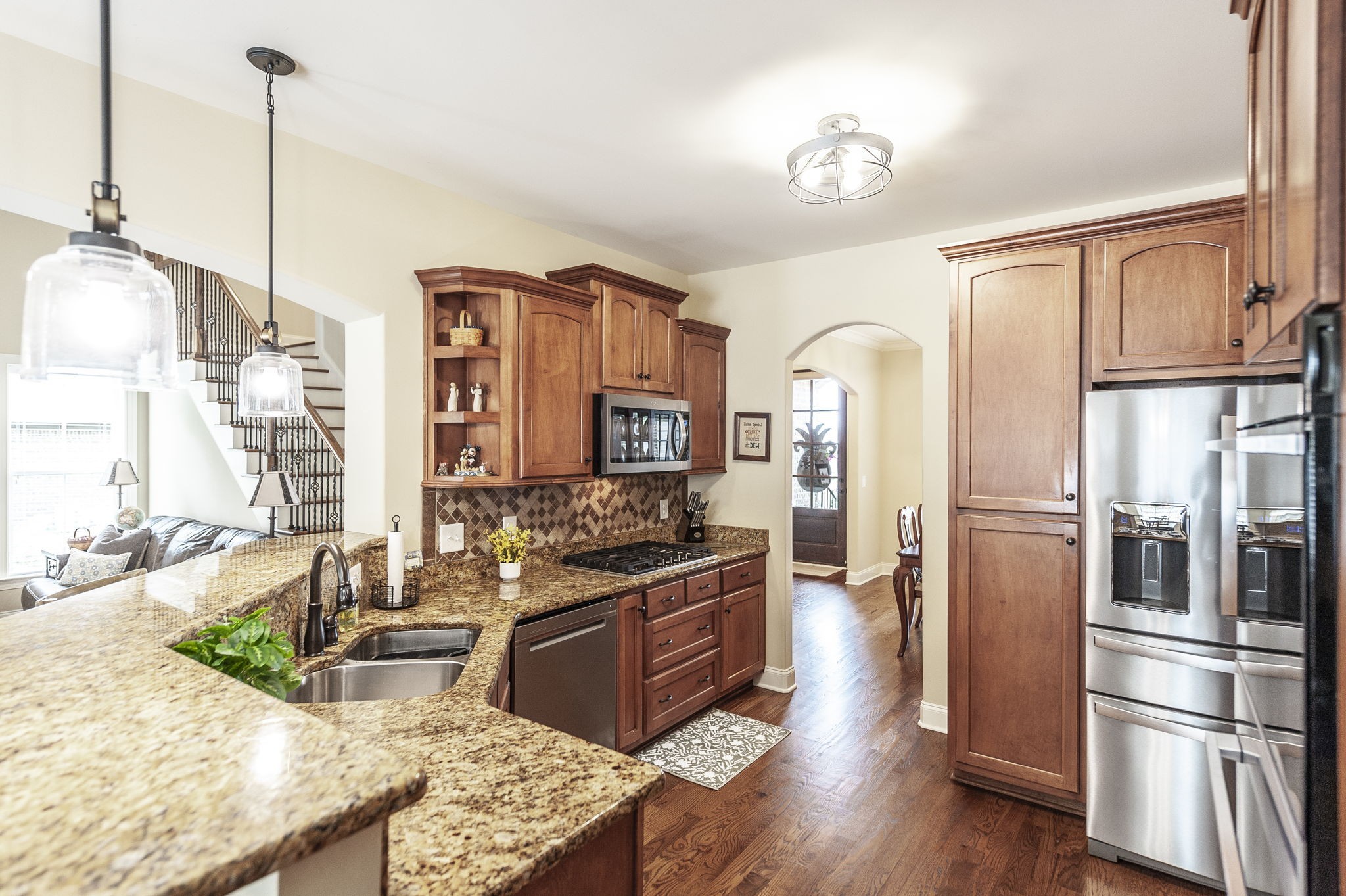 1017 Kendras Run Gallatin, TN 37066 - Photo 20 of 54 a kitchen with stainless steel appliances granite countertop a stove a refrigerator and a wooden floors